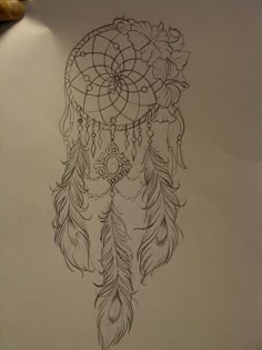 a drawing of a dream catcher with feathers