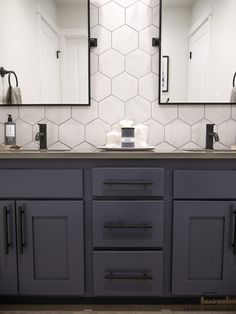 a bathroom with two sinks and mirrors on the wall