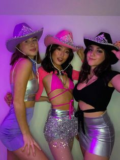 three women in disco outfits posing for the camera with their hands on their hipss