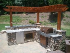 an outdoor bbq with grill and seating area