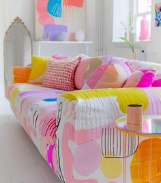 a living room filled with lots of colorful furniture