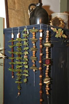 a bunch of beads hanging from a blue cabinet