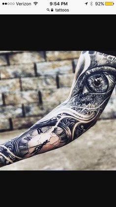 a man's arm with an eye tattoo on it