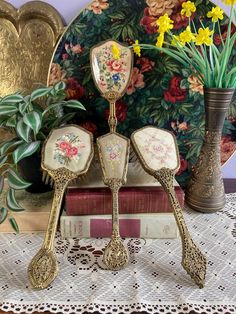 Vintage Filigree Nylon Hair Brushes, Dressing Table Set, Vanity Set, Petit Point, Embroidered, Gold Tone, Ornate Hair Brush  Beautiful Vanity Set Hair Brushes with gold tone handles All Made in England  Option 1. Regency Of London. Height 27cm. Pop Out Brushes. Very Good Condition. Looks Unused  Option 2,  Large Cabbage Rose Petit Point. Height 25cm. Brushes attached to wood. Good Condition Option 3. Rose Bouquet petit Point, Darker Colour Brushes attached to wood. A couple of wonky bristles. Wi Dressing Table Set, Styling Brush, Hair Brush, Rose Bouquet, Vanity Set, Dark Colors, Gold Tones, Hair Styles, Purses And Bags