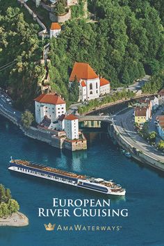 an aerial view of a cruise ship in the water next to a town and bridge