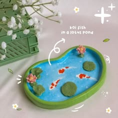 there is a small pond with koi fish in it and flowers on the side