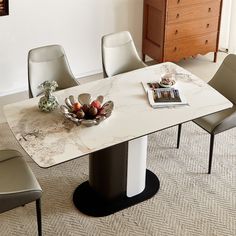 a marble dining table with chairs around it