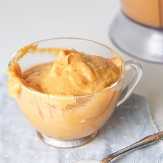 there is a small glass bowl with some food in it next to a blender