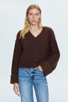 Textured, medium weight pullover sweater. Designed for boxy, relaxed silhouette with oversized cuffed sleeves, cropped length hem, and wide V open neckline. Oversized ribbing details at neckline, cuffs, and hem. Offered in a dark brown hue. 64% Acrylic / 13% Polyester / 9% Nylon / 8% Alpaca / 4% Wool / 2% Spandex Best Swimwear, Boxy Sweater, Knit Bottom, Textured Sweater, Football Tees, Dark Roast, Romper Pants, Cozy Sweaters, Cuff Sleeves