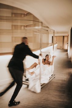 a man and woman in wedding attire are on a bed