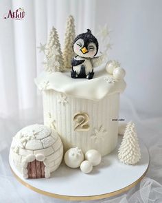 there is a cake that looks like a penguin on top of a building with decorations around it