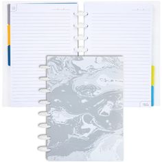 an open spiral bound notebook with marbled paper