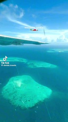 an airplane flying over some small islands in the ocean