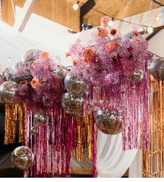 some silver and pink decorations hanging from the ceiling