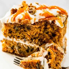 a piece of carrot cake on a plate with a fork