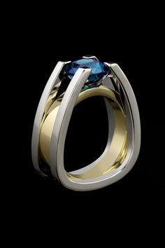 This architecturally inspired ring displays a dazzling deep blue tourmaline cut by Stephen Averysuspended in white gold with yellow gold accent.