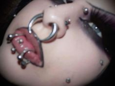 a close up of a woman's belly with rings on it