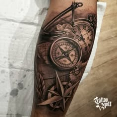 a man's arm with a clock and compass tattoo on it