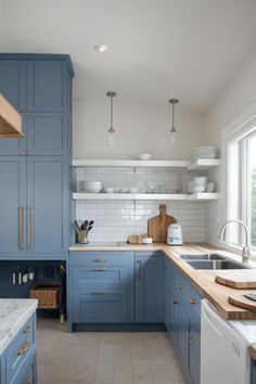 a kitchen with blue cabinets and white counter tops