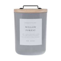 a candle that is sitting on top of a white surface with the words willow forest in front of it