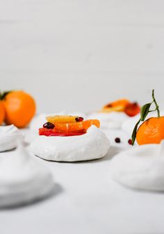 some oranges are sitting on top of whipped cream