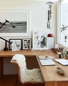 a desk with some pictures on the wall