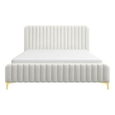 a white bed with a wooden headboard and foot board