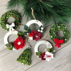 christmas wreaths hanging from the branches of a pine tree