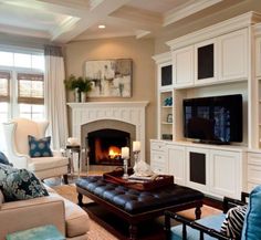 a living room filled with furniture and a fire place in the middle of it's wall