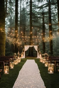 an outdoor ceremony with candles and lights on the aisle