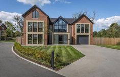 a large house sitting on top of a lush green field