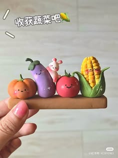 a person holding a small toy with vegetables on it