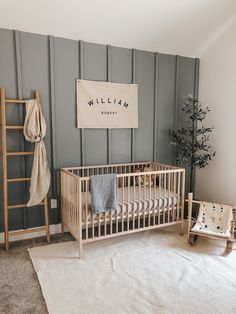 a baby's room with a wooden crib, ladder and blanket on the floor