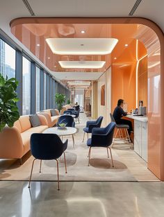 an office with orange walls and blue chairs