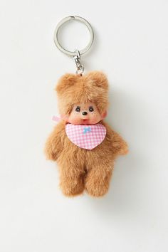 a brown teddy bear with a pink heart on it's chest is hanging from a keychain