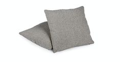 two gray pillows sitting on top of each other