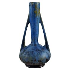 an old blue vase sitting on top of a table