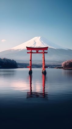 a large body of water with a mountain in the background and a red torido