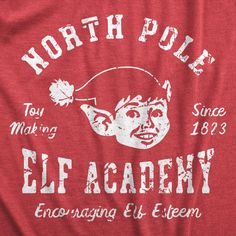 the north pole elf academy t - shirt is red with white lettering and an image of a man's head