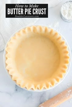 an uncooked pie crust on top of a white plate next to a rolling pin