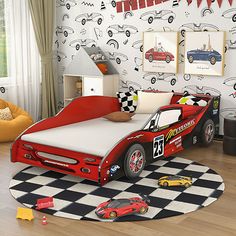 a child's bedroom decorated in red and black with race cars on the wall