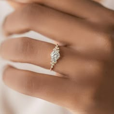 a woman's hand with a diamond ring on it