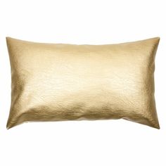 a gold pillow on a white background