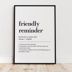 a black and white poster with the words friendly reminder on it in front of a wooden floor