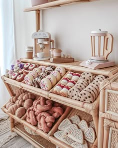 an assortment of cookies and pastries displayed in wicker baskets on a shelf next to a coffee maker