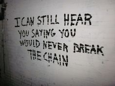 graffiti written on the side of a white brick wall that reads, i can still hear you saying you would never break the chain