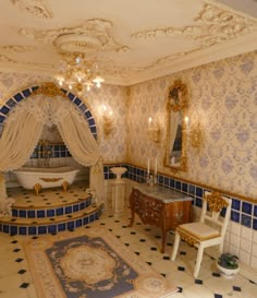 a fancy bathroom with blue and white tiles on the floor, chandelier, sink, tub and mirror