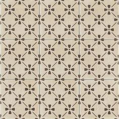 a white and brown tile pattern with small black flowers on the bottom half of it