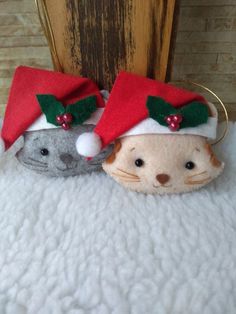 two small stuffed animals wearing christmas hats