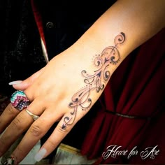 a woman's hand with a tattoo on it